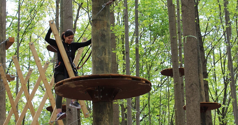 When Missy Connor set out to open TreeTrekkers in Frederick, Maryland, she had a clear vision for the project.  Though the 30-acre plot of privately owned and protected forest situated a few minutes outside of Downtown Frederick looked like just a wooded area next to the highway to most, to Missy ... it looked like a huge opportunity.  Having opened in fall 2019, TreeTrekkers is Frederick's first and only aerial challenge and zipline park. The park offers three adventure climbing areas, catering specifically to three different age groups and levels of ability. Within each area, a variety of courses with different obstacles and ziplines are available.  Missy wanted to create an environment that was fun for every member of the family and every person in any group. Very young climbers can explore the WanderWeb, where several obstacles are presented in the form of a web, rather than in a single direction. Expert climbers can challenge themselves on the black diamond courses, with elements over 65 feet up from the ground.  Including aspects of fun and teambuilding were both important to Missy, but preservation of the environment was equally crucial. In keeping with the TreeTrekkers mission, she is committed to protecting the existing tree canopy and natural features within the park. It's her hope that by exposing people of all ages to nature in a positive way, they too will have an appreciation for sustainability and preservation or our greatest resources.  Learn more and start planning your next adventure at Visit Frederick.  Written by Melissa Joseph Muntz, Marketing and Communications Manager, Visit Frederick.  Courtesy of Visit Frederick.